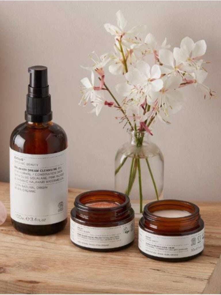 Evolve Organic Beauty skincare set on a wooden surface, showcasing eco-friendly packaging and botanical ingredients—perfect for conscious gifting.