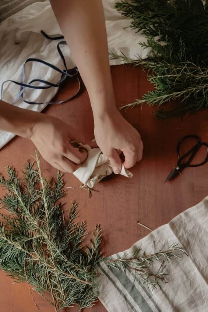 A gift being wrapped using the furoshiki method, using a vintage linen