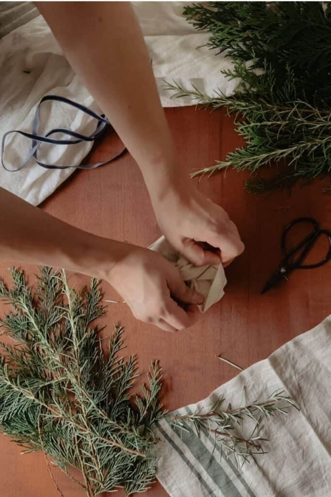 A gift being wrapped using the furoshiki method, using a vintage linen