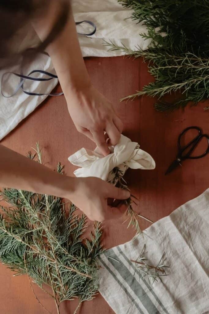 A gift being wrapped using the furoshiki method, using a vintage linen