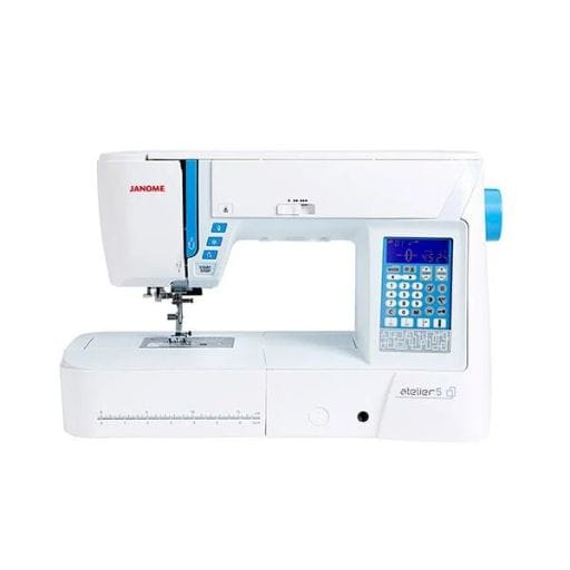 A white Janome sewing machine, model Atelier 5, perfect for a craft blogger, features a digital display with blue backlight and buttons for various settings. Its functional design includes a visible needle area and measurement guide, ideal for creative projects.