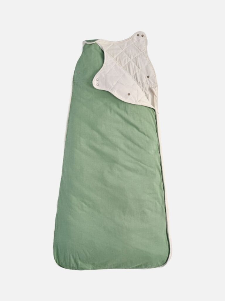 A soft green organic bamboo Pure Earth sleeping bag for babies, featuring natural fiber lining and snap closures—a cozy and sustainable sleep solution.