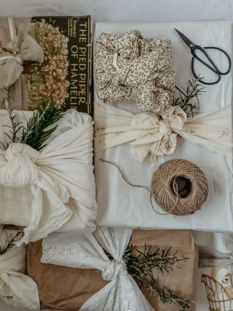 Beautifully wrapped gifts using natural fabrics, lace, twine, and sprigs of greenery—an elegant, waste-free alternative to traditional wrapping paper.