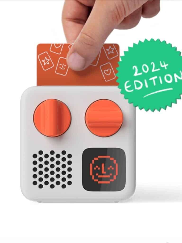 A compact Yoto Mini audio player with orange dials and a card slot, designed for screen-free storytelling—an engaging and sustainable kids' gift.
