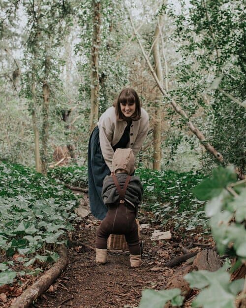 Innes walks in the woods, looking back and smiling at her little boy. This images should what aboderie is all about!